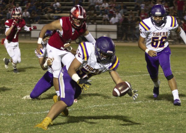 Tiger linebacker Sione Hanna recovers a Chowchilla fumble in Friday's 26-16 victory over Chowchilla. Lemoore will host Tulare Western on Friday night in its home opener.